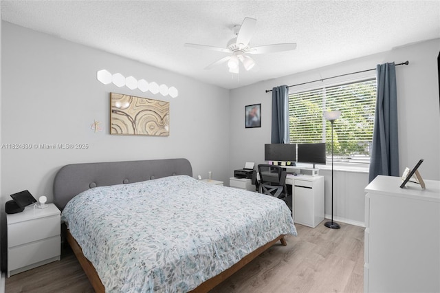 11000 Sand Piper Ct, Tamarac, FL 33321 - bedroom with light wood-type flooring, a textured ceiling, a ceiling fan, and a desk
