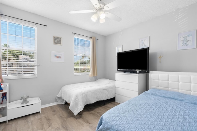 11000 Sand Piper Ct, Tamarac, FL 33321 - bedroom with wood finished floors, a textured ceiling, and a ceiling fan