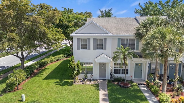 11000 Sand Piper Ct, Tamarac, FL 33321 - view of front of home featuring stucco siding, a front lawn, and roof with shingles