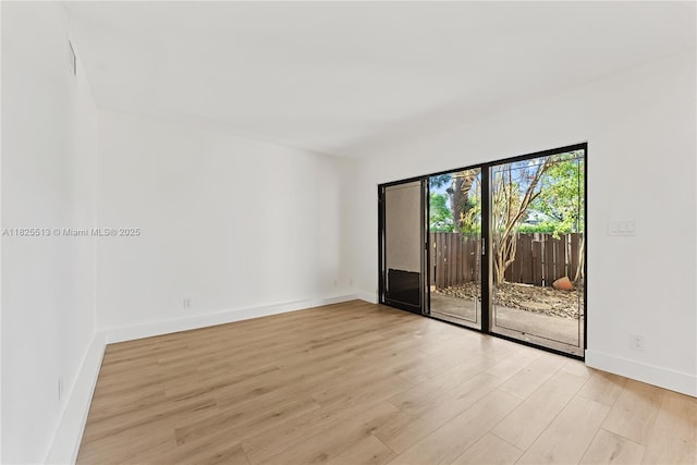 7720 NW 79th Ave Unit B6, Tamarac, FL 33321 - unfurnished room with light wood-style floors and baseboards