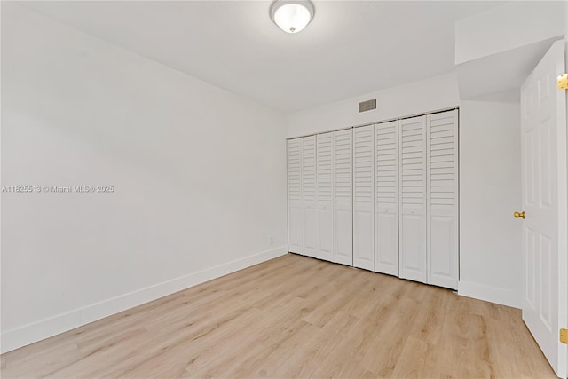 7720 NW 79th Ave Unit B6, Tamarac, FL 33321 - unfurnished bedroom featuring light wood-style flooring and a closet