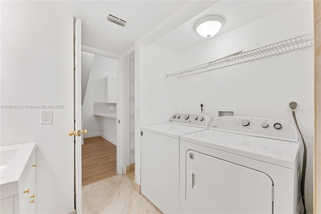 7720 NW 79th Ave Unit B6, Tamarac, FL 33321 - laundry area with washer and dryer and baseboards