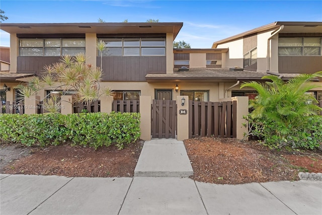 7720 NW 79th Ave Unit B6, Tamarac, FL 33321 - view of front of property featuring stucco siding, a gate, and a fenced front yard