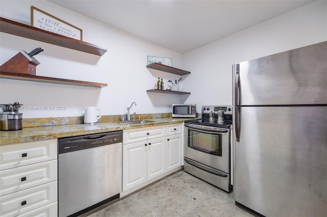 1020 Meridian Ave Unit 816, Miami Beach, FL 33139 - kitchen featuring open shelves, appliances with stainless steel finishes, white cabinetry, and concrete floors