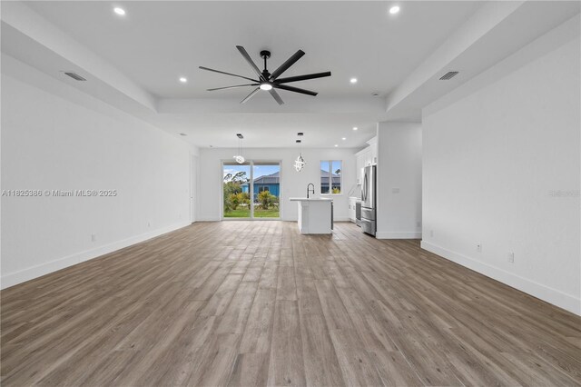 10071 Kingsville Prt, Charlotte, FL 33981 - unfurnished living room with recessed lighting, wood finished floors, and ceiling fan