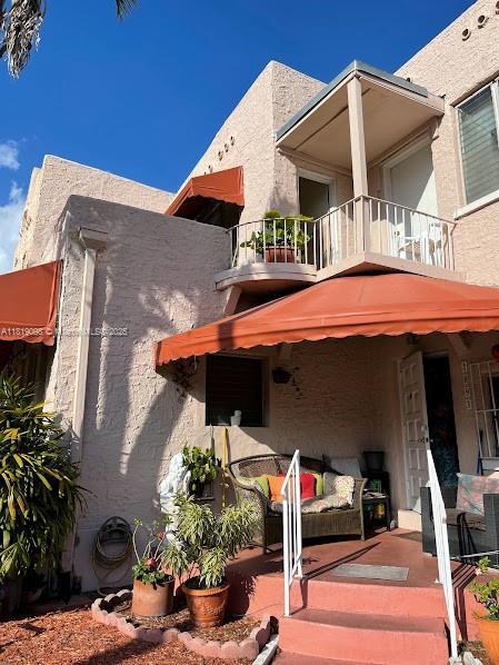 829 SW 19th Ave, Miami, FL 33135 - back of property with a balcony and stucco siding