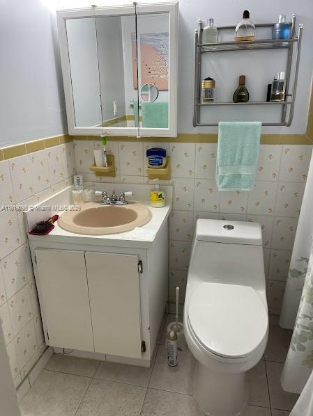 829 SW 19th Ave, Miami, FL 33135 - bathroom with vanity, wainscoting, tile walls, and tile patterned floors