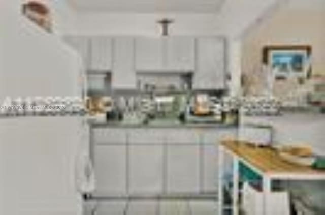 829 SW 19th Ave, Miami, FL 33135 - kitchen featuring white cabinets