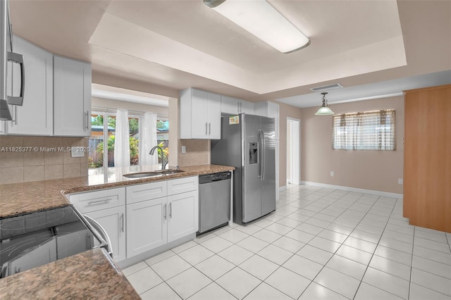 9200 SW 54th St, Cooper City, FL 33328 - kitchen featuring stainless steel appliances, a raised ceiling, backsplash, and white cabinetry