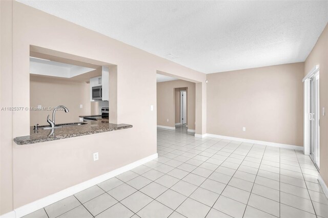9200 SW 54th St, Cooper City, FL 33328 - empty room featuring a textured ceiling and light tile patterned flooring