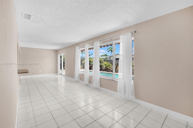 9200 SW 54th St, Cooper City, FL 33328 - empty room featuring a textured ceiling and light tile patterned flooring