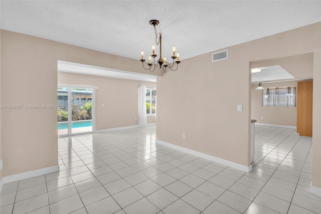 9200 SW 54th St, Cooper City, FL 33328 - empty room with light tile patterned floors, a textured ceiling, and a chandelier