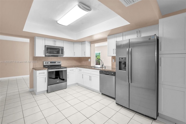 9200 SW 54th St, Cooper City, FL 33328 - kitchen with stainless steel appliances, a raised ceiling, light tile patterned flooring, and white cabinetry