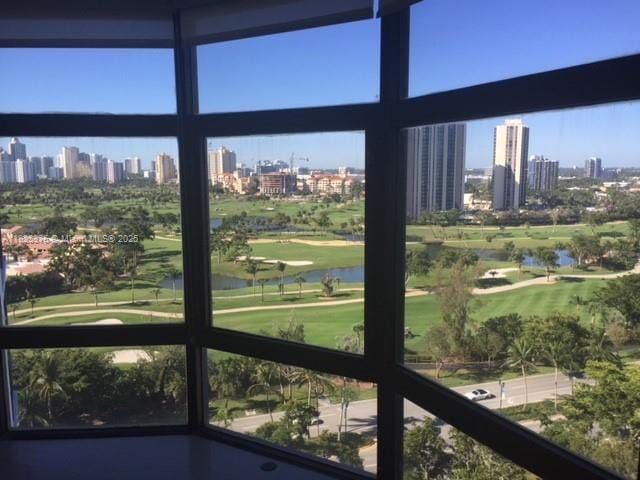 3375 N Country Club Dr Unit 1508, Aventura, FL 33180 - unfurnished sunroom featuring a skyline view, a water view, and healthy amount of natural light
