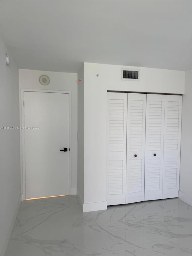 800 N Miami Ave Unit E-901, Miami, FL 33136 - unfurnished bedroom with marble look tiles and a closet