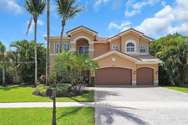 11844 Foxbriar Lake Trl, Boynton Beach, FL 33473 - mediterranean / spanish home with stucco siding, decorative driveway, a front lawn, and a tiled roof
