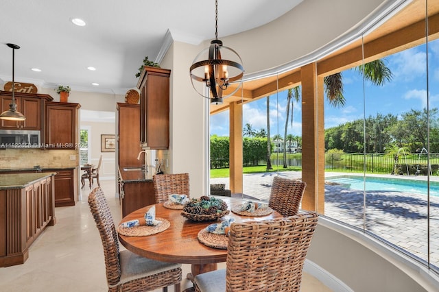 11844 Foxbriar Lake Trl, Boynton Beach, FL 33473 - dining area featuring a chandelier, recessed lighting, light tile patterned floors, and crown molding