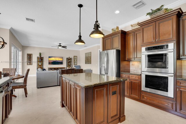 11844 Foxbriar Lake Trl, Boynton Beach, FL 33473 - kitchen featuring stainless steel appliances, crown molding, a center island, decorative light fixtures, and dark stone counters
