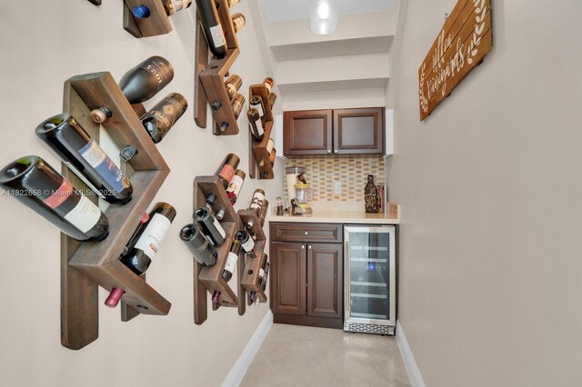 11844 Foxbriar Lake Trl, Boynton Beach, FL 33473 - indoor dry bar with wine cooler, tasteful backsplash, and light tile patterned flooring