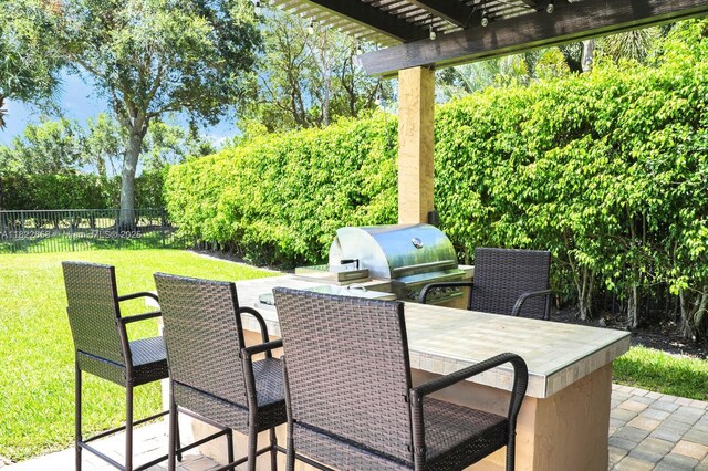 11844 Foxbriar Lake Trl, Boynton Beach, FL 33473 - view of patio with outdoor dining area, a pergola, and exterior kitchen