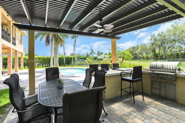 11844 Foxbriar Lake Trl, Boynton Beach, FL 33473 - fenced backyard with an outdoor kitchen, a pergola, exterior bar, a patio, and a ceiling fan