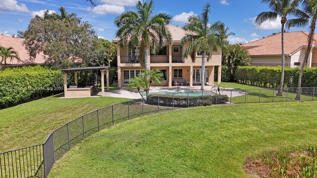 11844 Foxbriar Lake Trl, Boynton Beach, FL 33473 - rear view of property with a balcony, stucco siding, a patio, and a fenced backyard