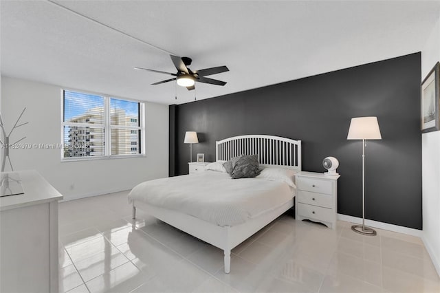 2000 S Ocean Blvd Unit 11M, Lauderdale By The Sea, FL 33062 - bedroom featuring an accent wall, a ceiling fan, and light tile patterned flooring