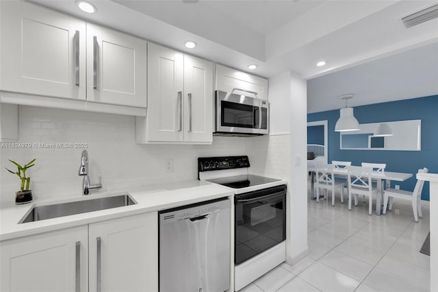 2000 S Ocean Blvd Unit 11M, Lauderdale By The Sea, FL 33062 - kitchen featuring appliances with stainless steel finishes, decorative backsplash, recessed lighting, light tile patterned flooring, and white cabinetry