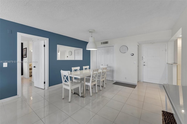 2000 S Ocean Blvd Unit 11M, Lauderdale By The Sea, FL 33062 - dining room featuring a textured ceiling and light tile patterned floors