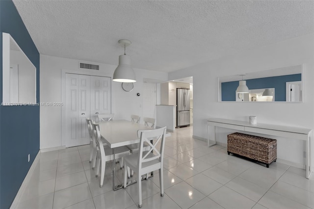 2000 S Ocean Blvd Unit 11M, Lauderdale By The Sea, FL 33062 - dining area with light tile patterned floors and a textured ceiling