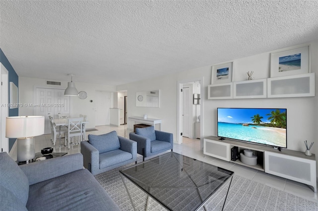 2000 S Ocean Blvd Unit 11M, Lauderdale By The Sea, FL 33062 - living area featuring light tile patterned floors and a textured ceiling