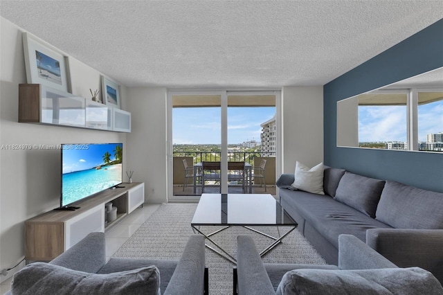 2000 S Ocean Blvd Unit 11M, Lauderdale By The Sea, FL 33062 - living room with a textured ceiling, expansive windows, and tile patterned floors