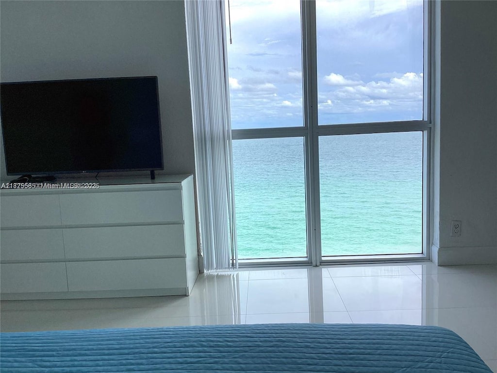 3901 S Ocean Dr Unit 12E, Hollywood, FL 33019 - bedroom with tile patterned flooring, multiple windows, and a water view