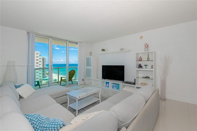 3901 S Ocean Dr Unit 12E, Hollywood, FL 33019 - living area with expansive windows, tile patterned floors, and a textured ceiling