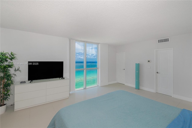 3901 S Ocean Dr Unit 12E, Hollywood, FL 33019 - bedroom featuring tile patterned flooring and a textured ceiling