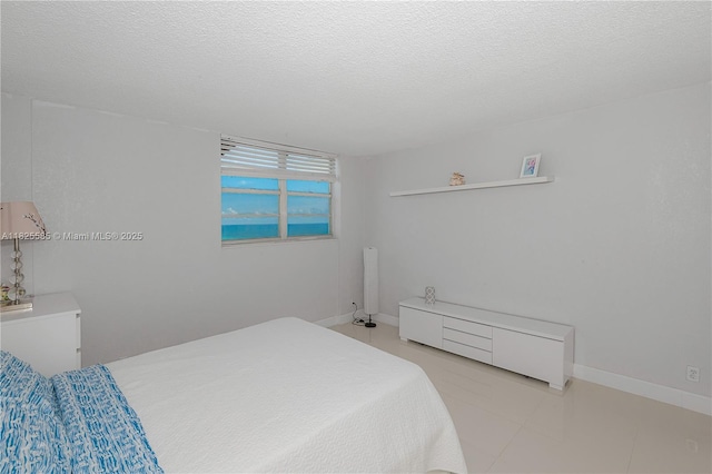 3901 S Ocean Dr Unit 12E, Hollywood, FL 33019 - bedroom featuring a textured ceiling and baseboards
