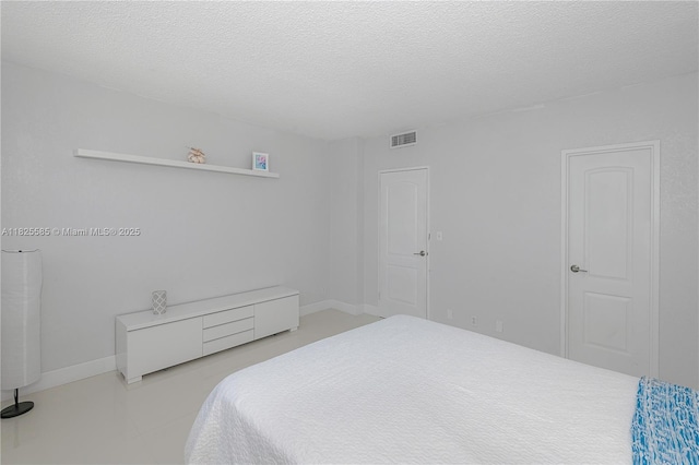3901 S Ocean Dr Unit 12E, Hollywood, FL 33019 - bedroom with a textured ceiling and baseboards