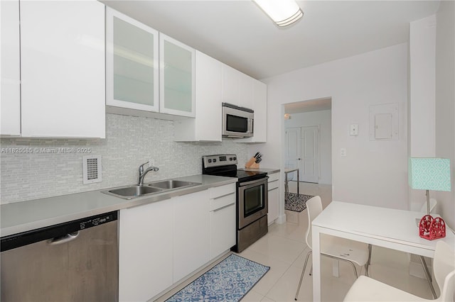 3901 S Ocean Dr Unit 12E, Hollywood, FL 33019 - kitchen with stainless steel appliances, white cabinetry, decorative backsplash, and light countertops