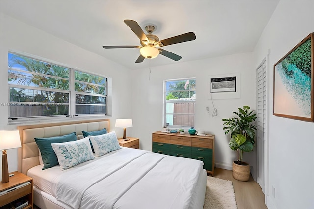 5615 Branch St, Hollywood, FL 33021 - bedroom featuring light wood finished floors, a wall mounted air conditioner, and a ceiling fan