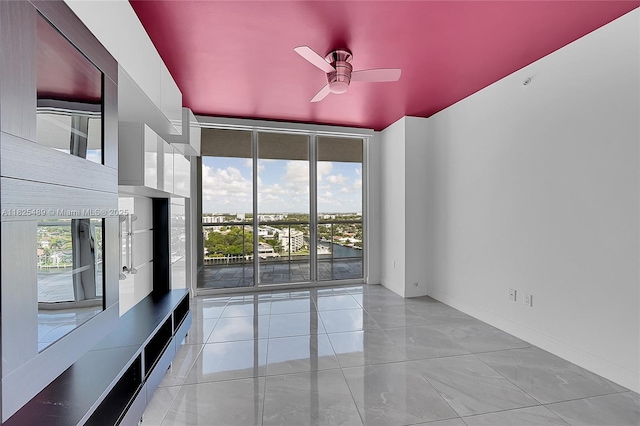 1 N Ocean Blvd Unit 1211, Pompano Beach, FL 33062 - spare room featuring ceiling fan and expansive windows
