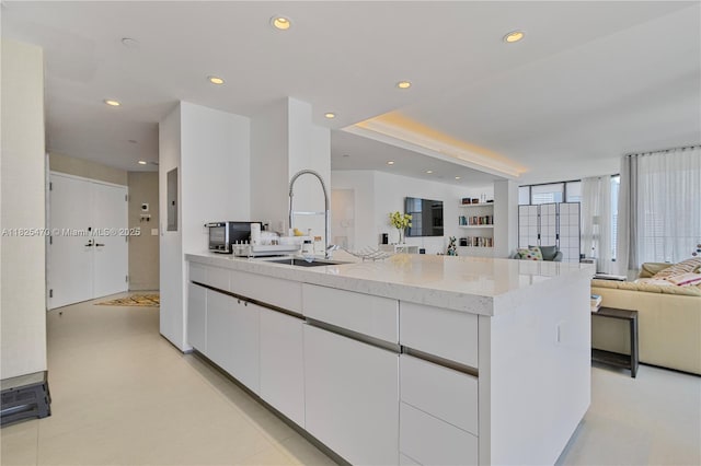520 Brickell Key Dr Unit A1421, Miami, FL 33131 - kitchen featuring open floor plan, recessed lighting, white cabinets, light stone counters, and electric panel