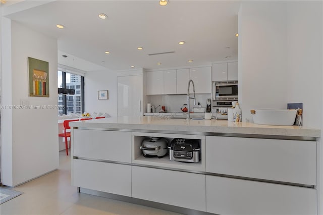 520 Brickell Key Dr Unit A1421, Miami, FL 33131 - kitchen with stainless steel appliances, modern cabinets, white cabinetry, light countertops, and recessed lighting