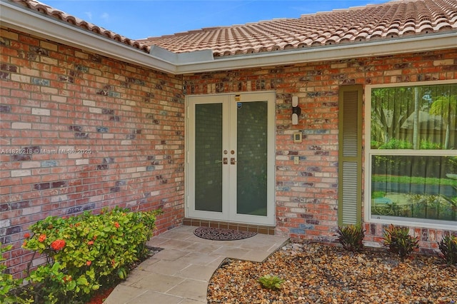 10967 NW 12th Dr, Coral Springs, FL 33071 - entrance to property featuring french doors, a tiled roof, and brick siding