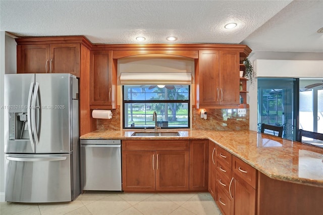 10967 NW 12th Dr, Coral Springs, FL 33071 - kitchen featuring appliances with stainless steel finishes, brown cabinets, open shelves, light stone counters, and decorative backsplash