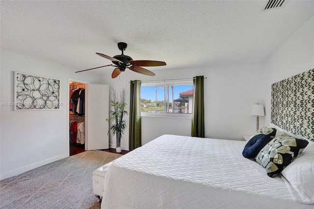 10967 NW 12th Dr, Coral Springs, FL 33071 - bedroom with a spacious closet, a closet, a textured ceiling, and ceiling fan