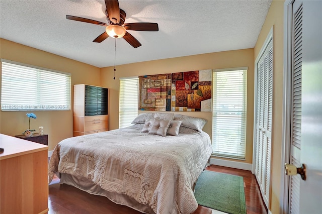 10967 NW 12th Dr, Coral Springs, FL 33071 - bedroom with wood finished floors, multiple windows, a textured ceiling, and ceiling fan