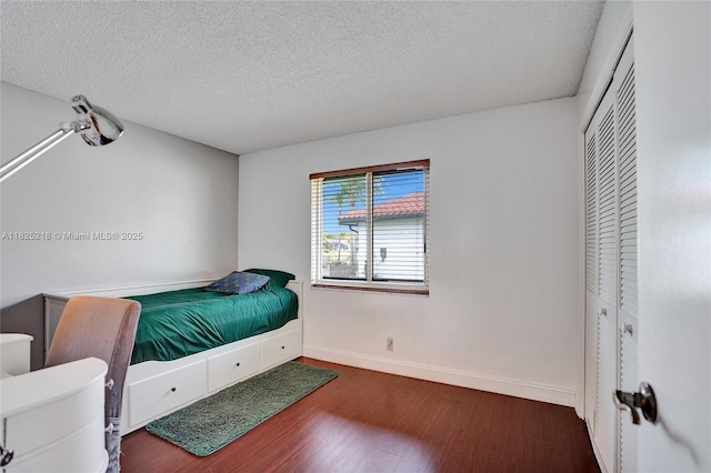 10967 NW 12th Dr, Coral Springs, FL 33071 - bedroom with wood finished floors, a textured ceiling, and a closet