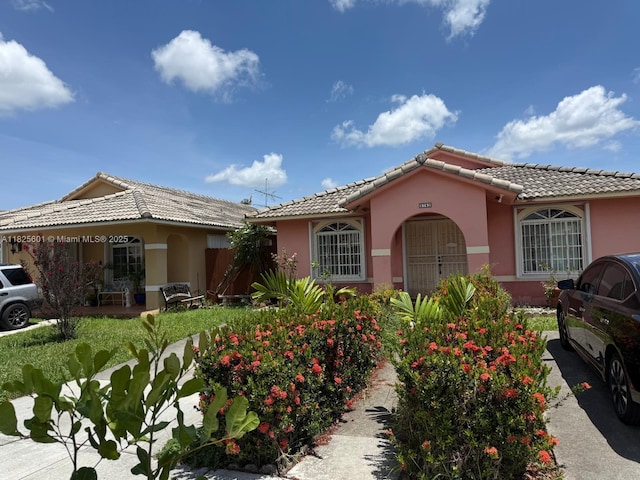9703 NW 127th St, Hialeah Gardens, FL 33018 - view of front of home featuring a tile roof and stucco siding