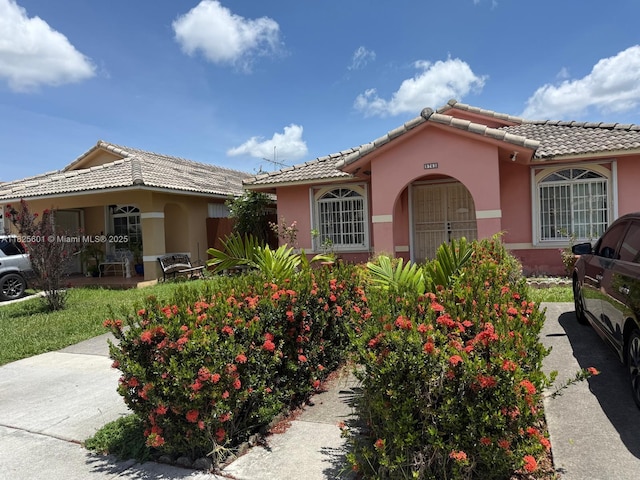 9703 NW 127th St, Hialeah Gardens, FL 33018 - view of front of property with a tiled roof and stucco siding