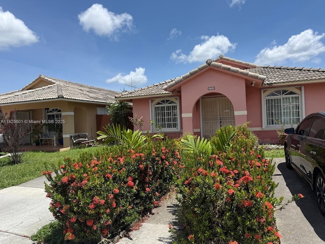 9703 NW 127th St, Hialeah Gardens, FL 33018 - view of front of property with a tiled roof and stucco siding